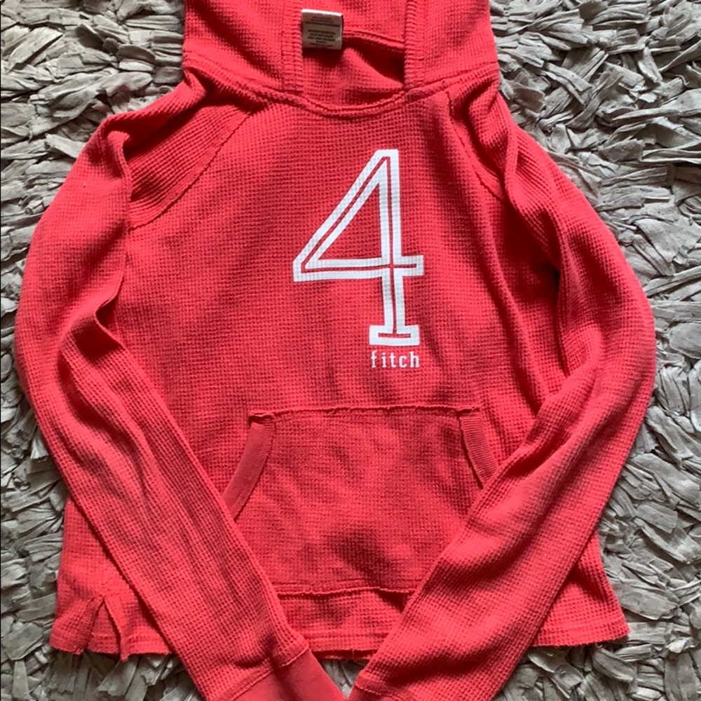 A pink Abercrombie Kids hoodie.